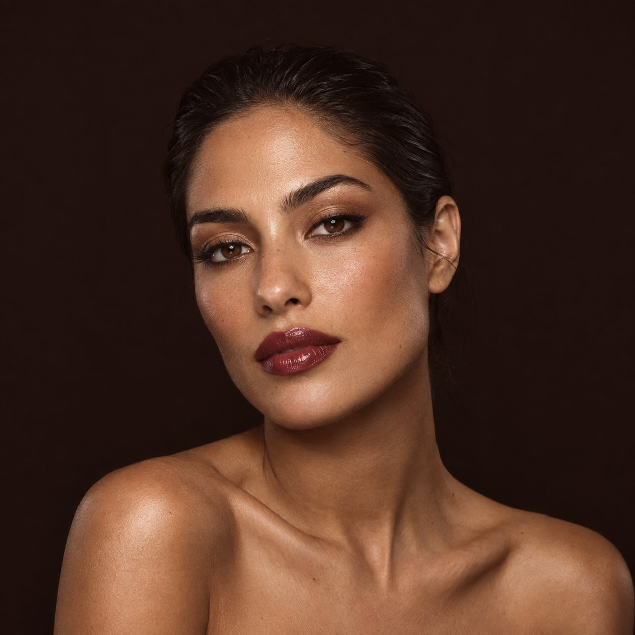 Beauty portrait with bronze eye makeup and glossy berry lips